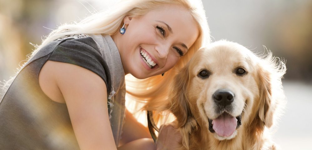 Happy And Cheerful Woman With Her Dog.