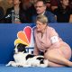 An Image Of Jack Russell Terrier Sitting With His Owner In A Pet Show.